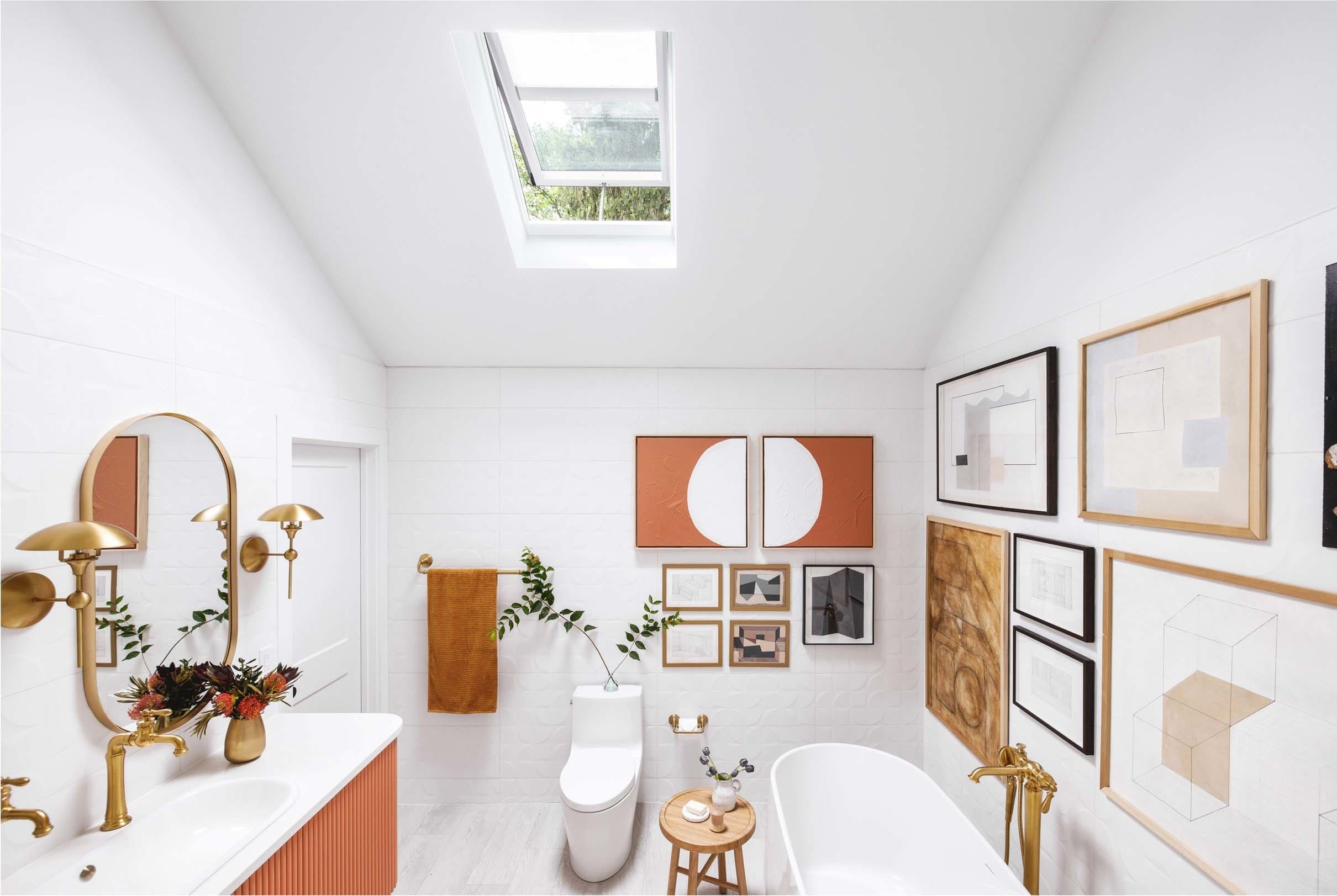 white and terracotta bathroom with skylight and gallery wall