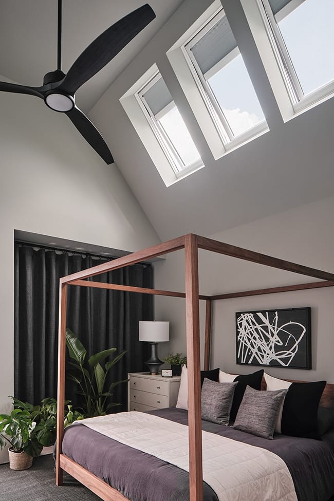 Bedroom with skylights gray white with wood canopy bed