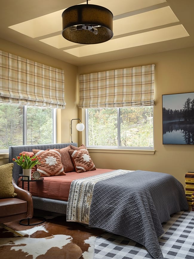 Bedroom with yellow walls and ceiling with three skylights