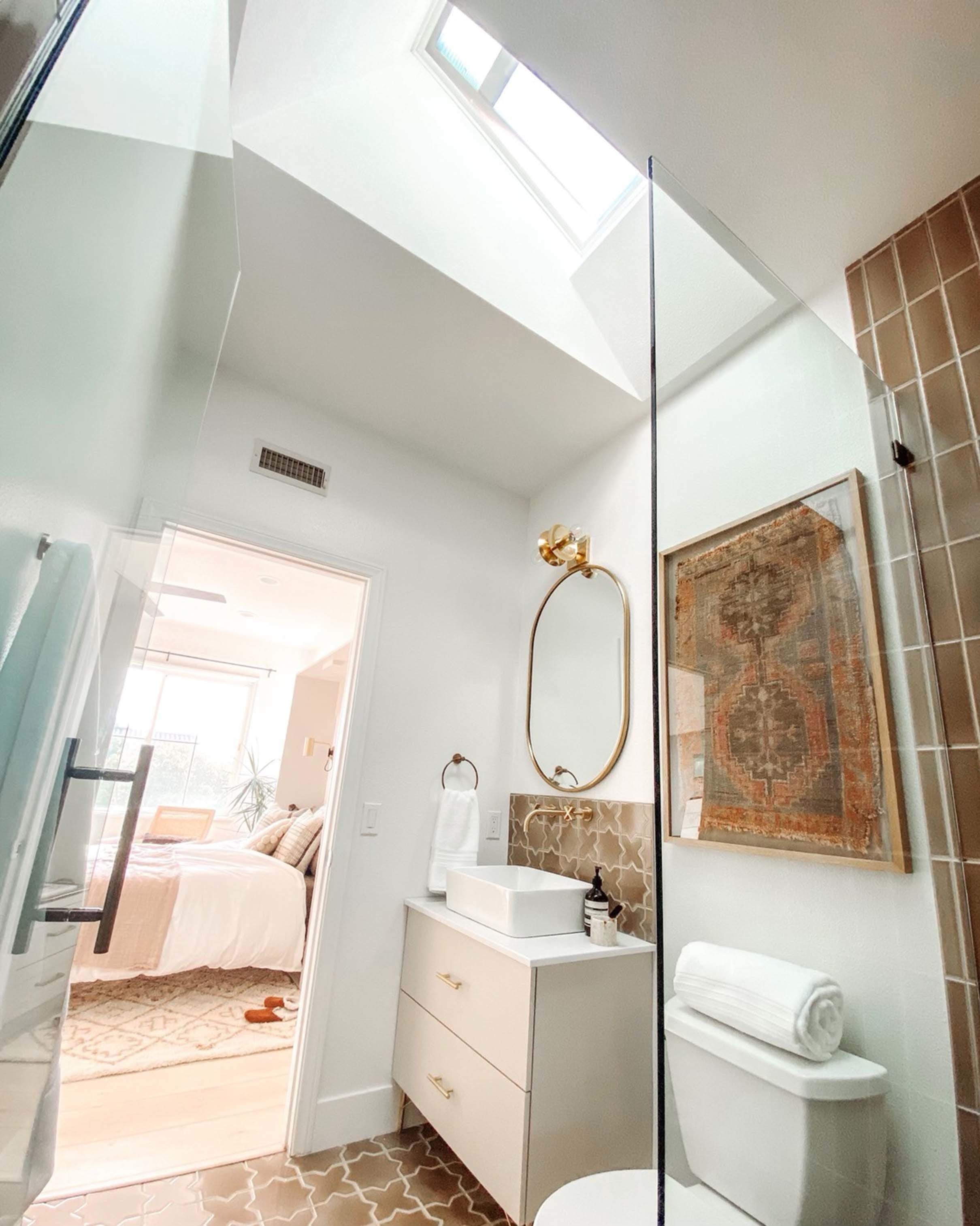 Small bathroom brown tan brass skylight